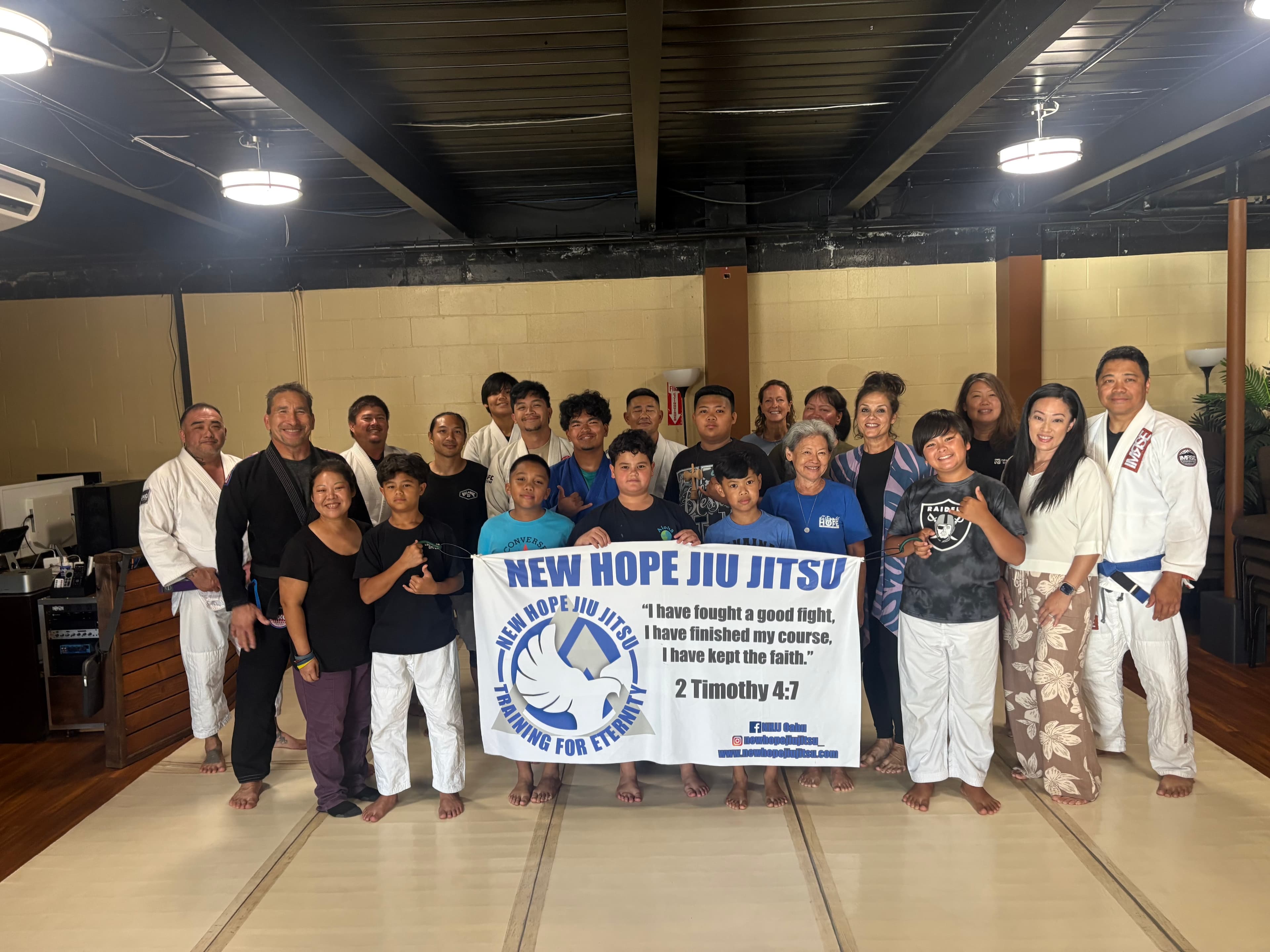 Sunday class on August 30, 2026 — kids and adults holding the Training for Eternity banner in Waipahu